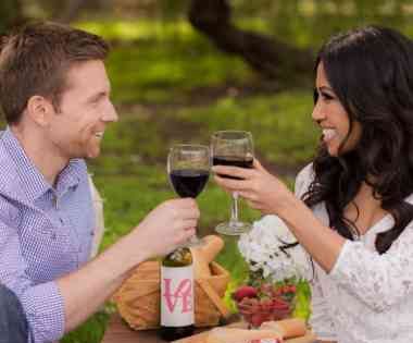 Man and lady toasting with glasses of white wine