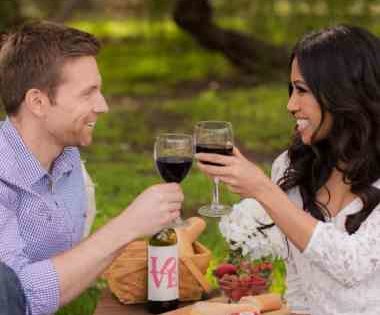 Man and lady toasting with glasses of white wine