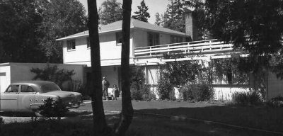 Historical view of home with older model car