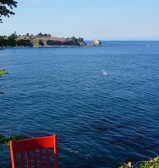 Red Chair sitting on shore