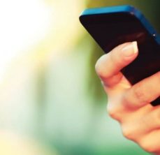 Person holding cellphone indicating free WiFi